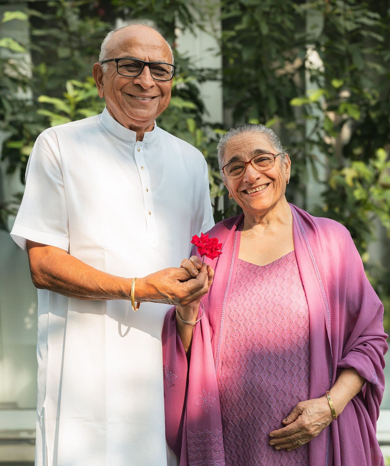 A smiling retired couple standing together outdoors